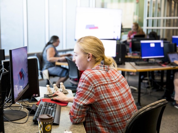 Woman working at a computer at Hackathon
