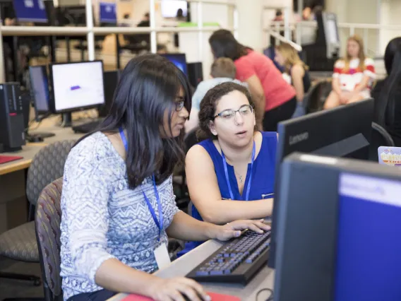 Two women working together at Hackathon