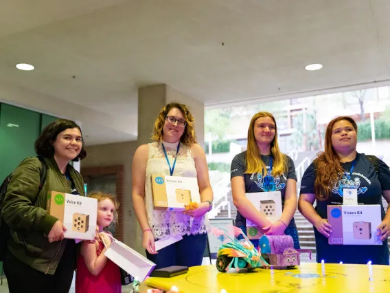 Participants holding up hackathon kits