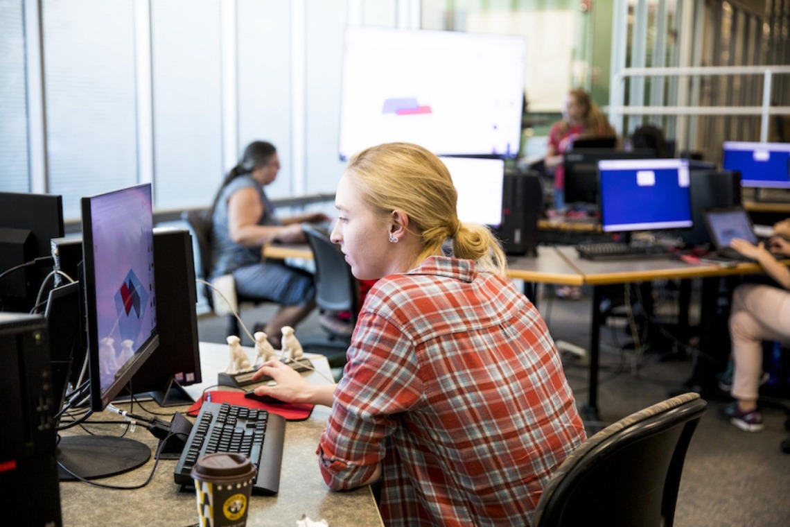 Woman working at a computer at Hackathon