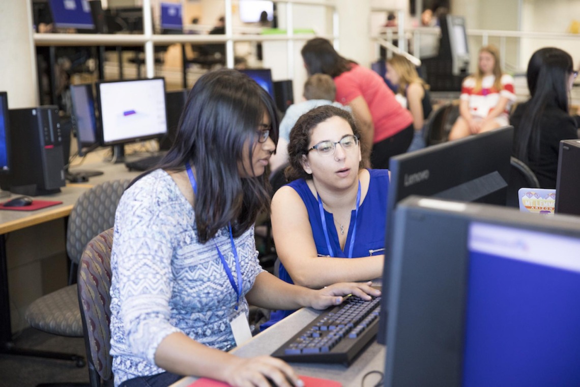 Two women working together at Hackathon