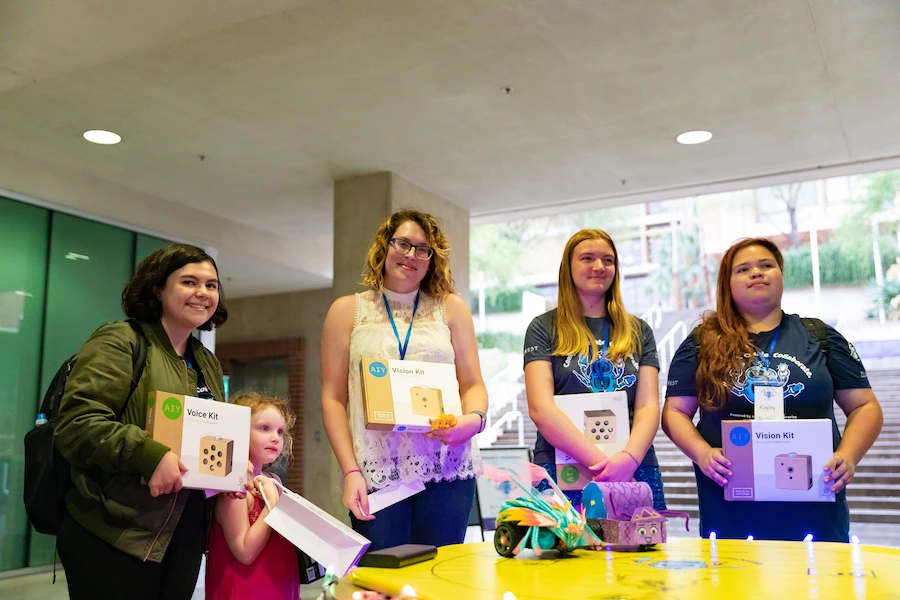 Participants holding up hackathon kits